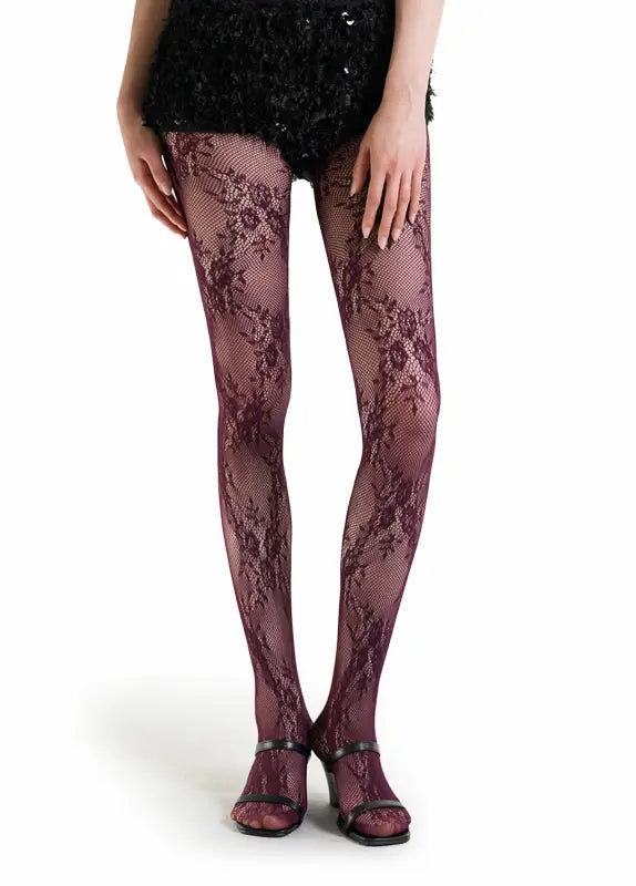 Burgundy lace tights worn by a person on a white background