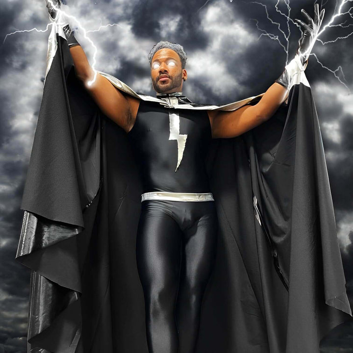 Cosplay performer wearing a black Speerise unitard with a cape and metallic accessories