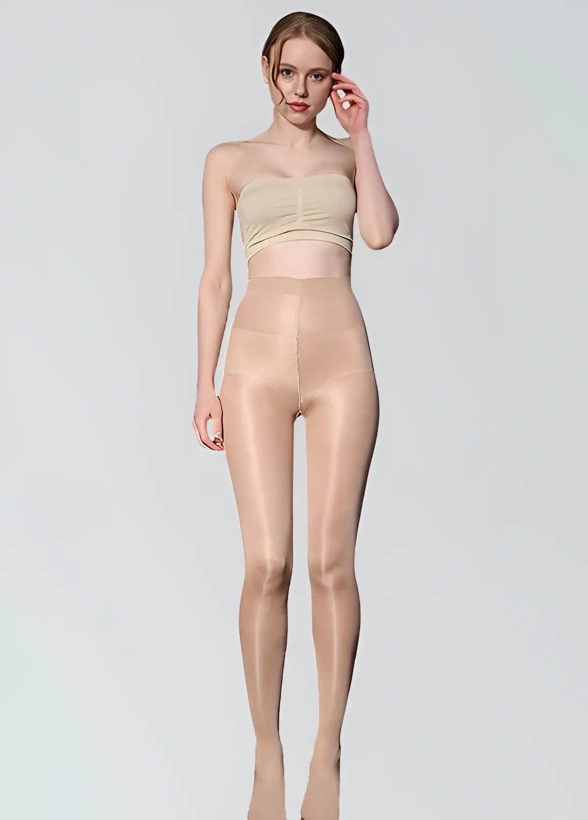 Woman wearing beige shapewear on a plain background