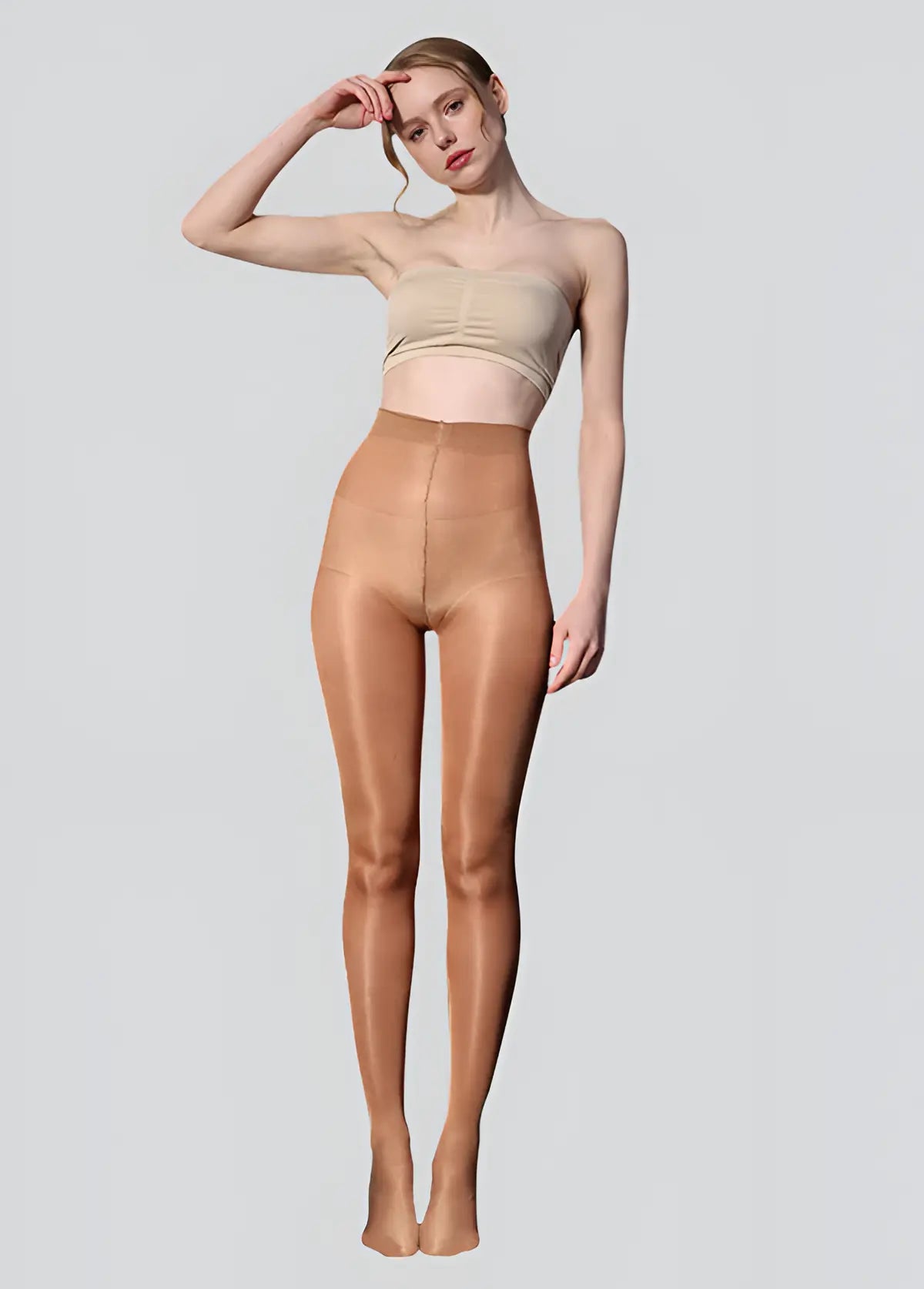 Woman wearing beige shapewear on a plain background