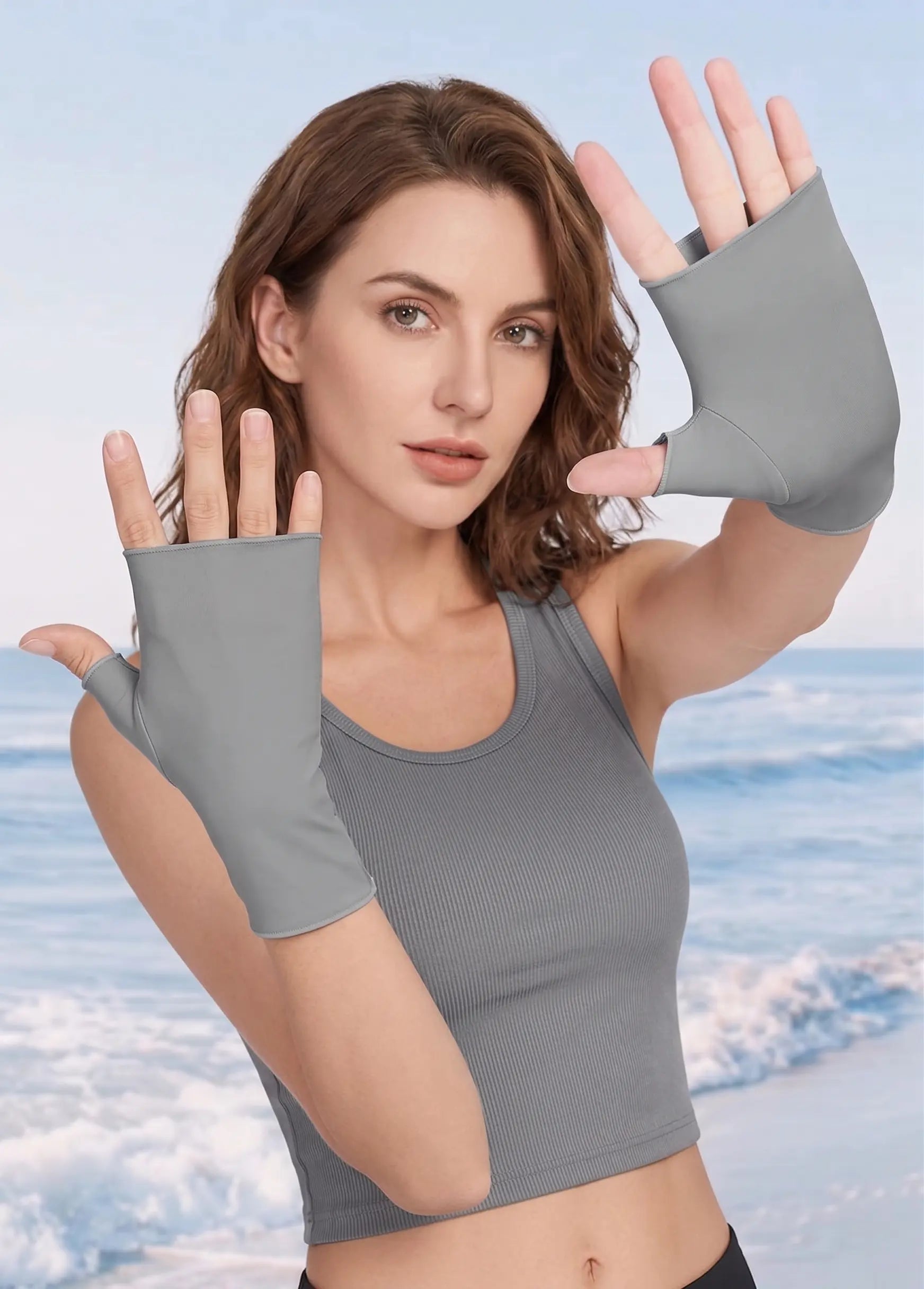 Woman wearing gray fingerless gloves against a sky background