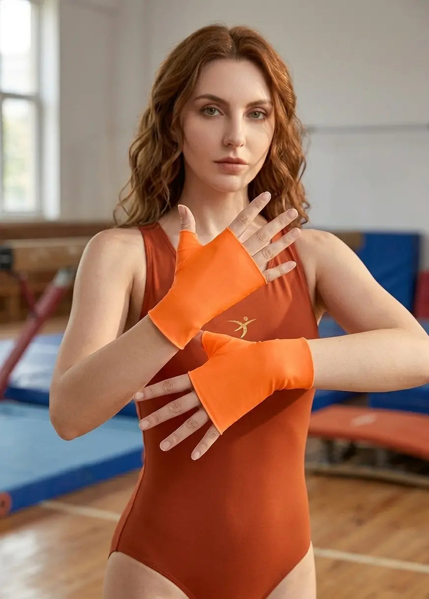 Orange fingerless gloves worn on a plain background